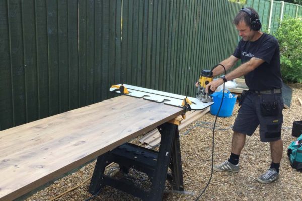 corby-carpenter-routing-worktops mccaffreys-working-on-fitting-new-worktop-in-corby